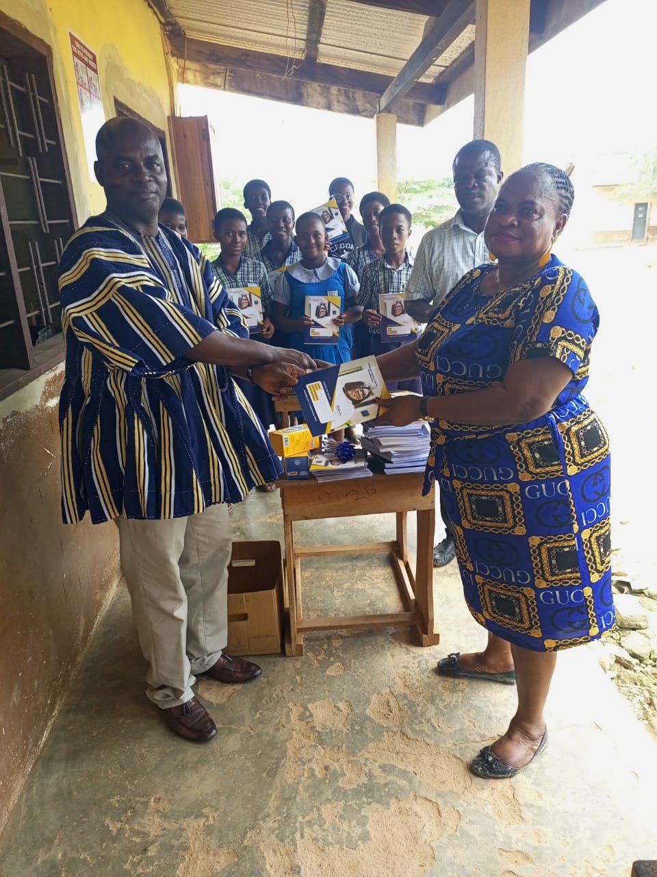 Handing over books to a basic school