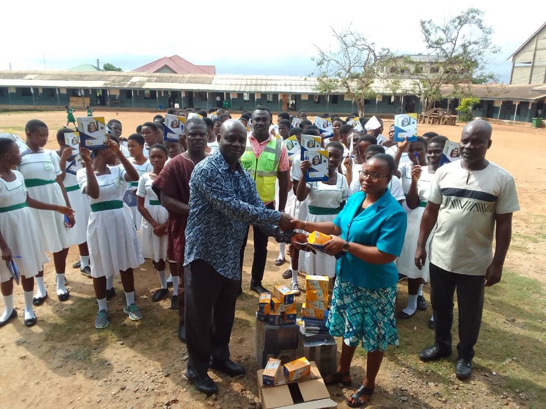 Handing over donated items to the headmistress