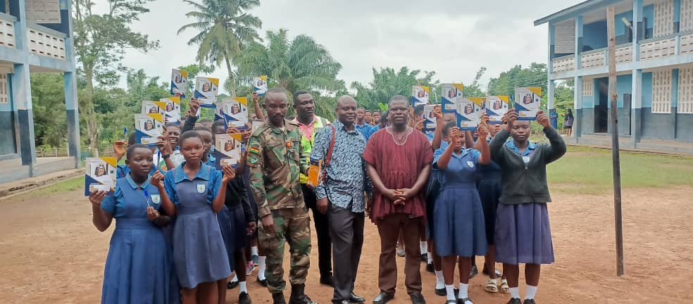 Students and officials with donated exercise books