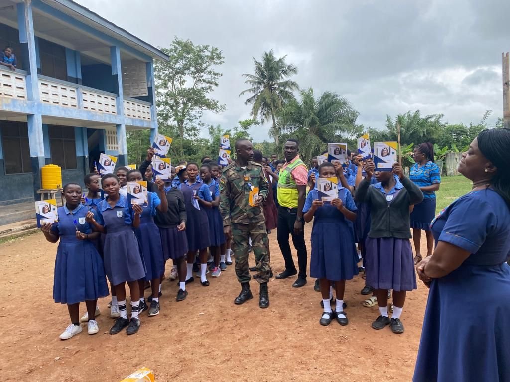 Schoolgirls holding donated items